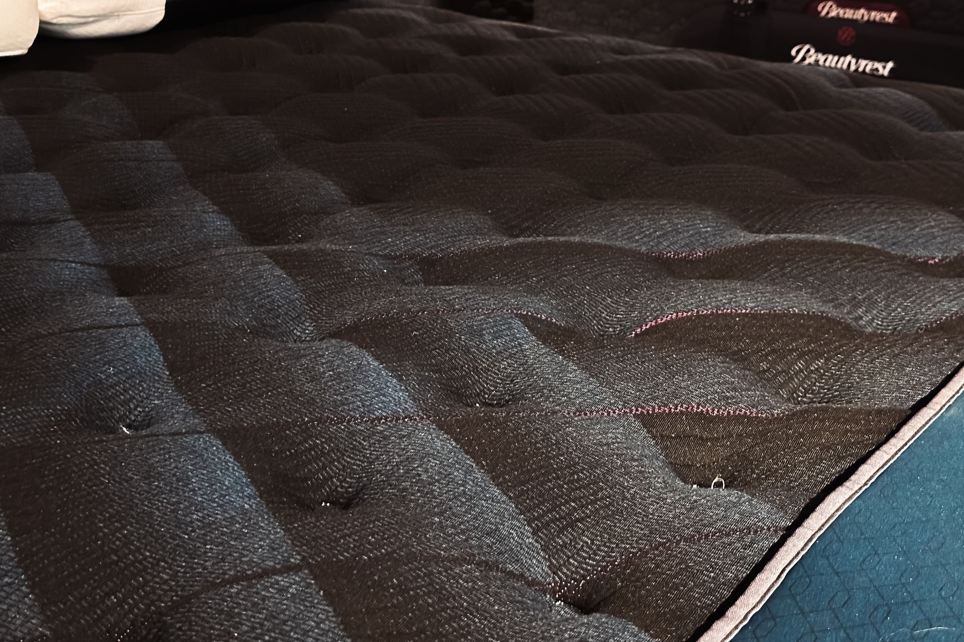 A stuffed turtle is sitting on top of a mattress.