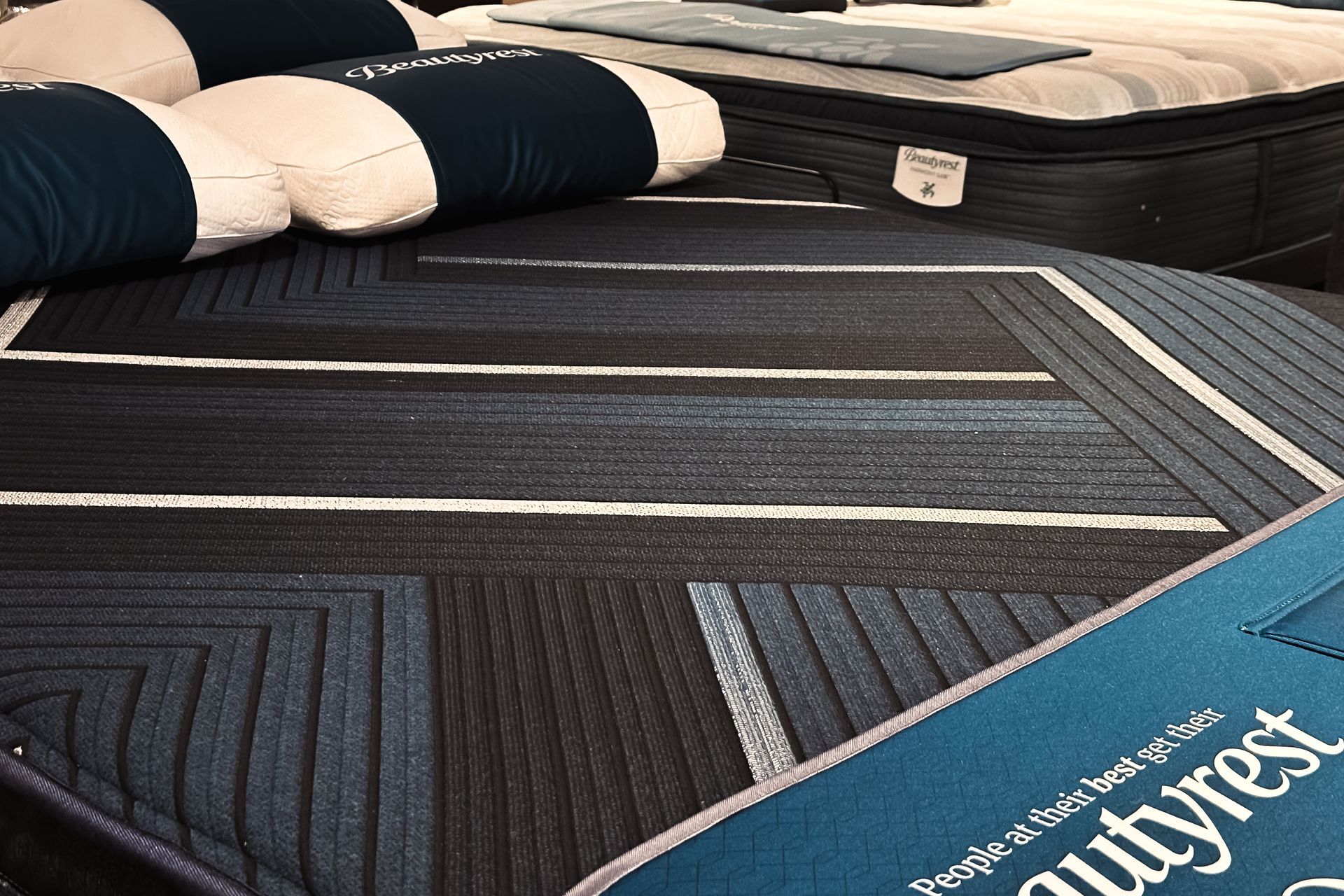 A mattress store filled with lots of mattresses and pillows.