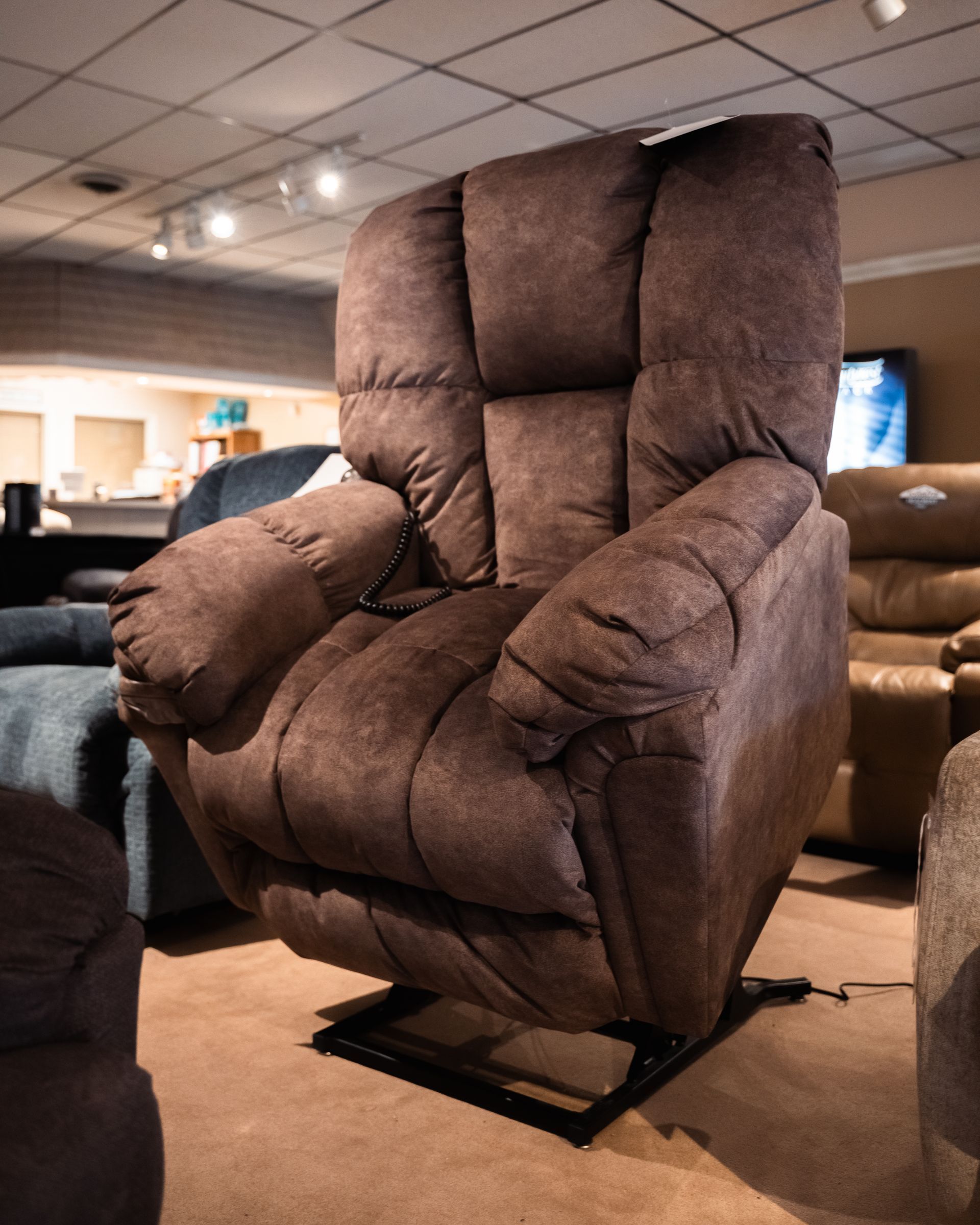 A large brown recliner is sitting in a living room