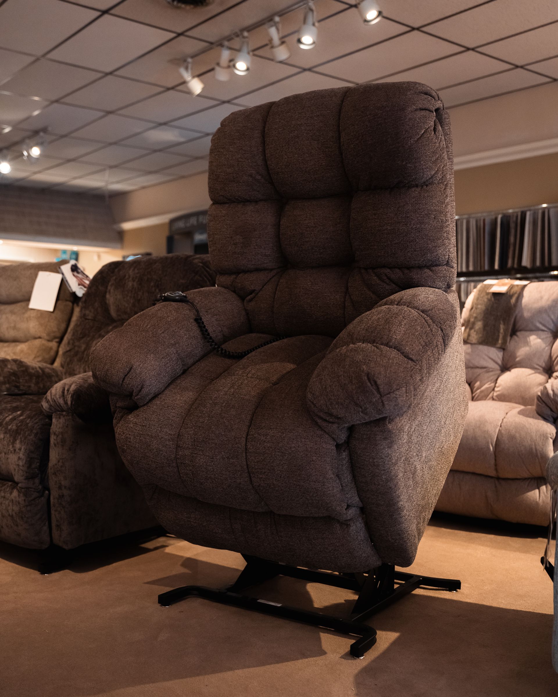 A large brown recliner is sitting in a living room