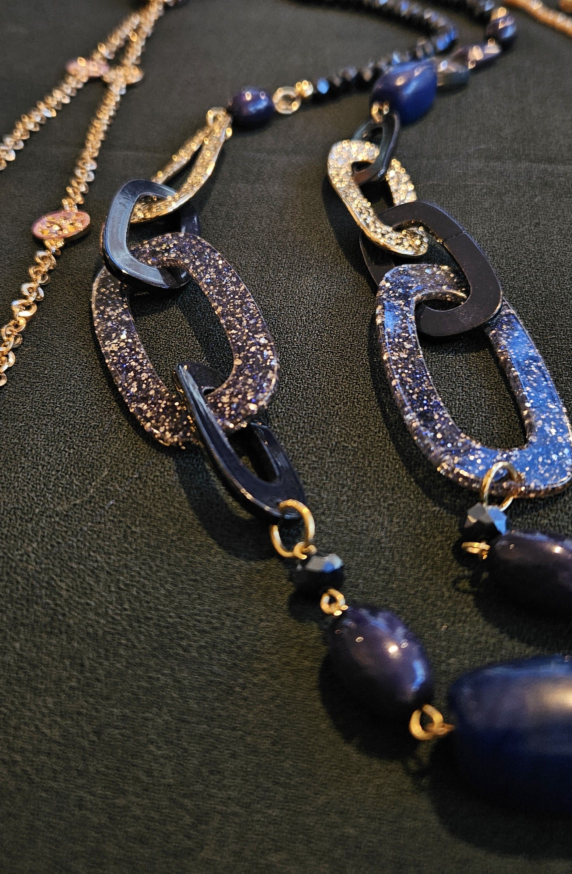 Close-up van 2 blauwe kettingschakels op een zwarte achtergrond