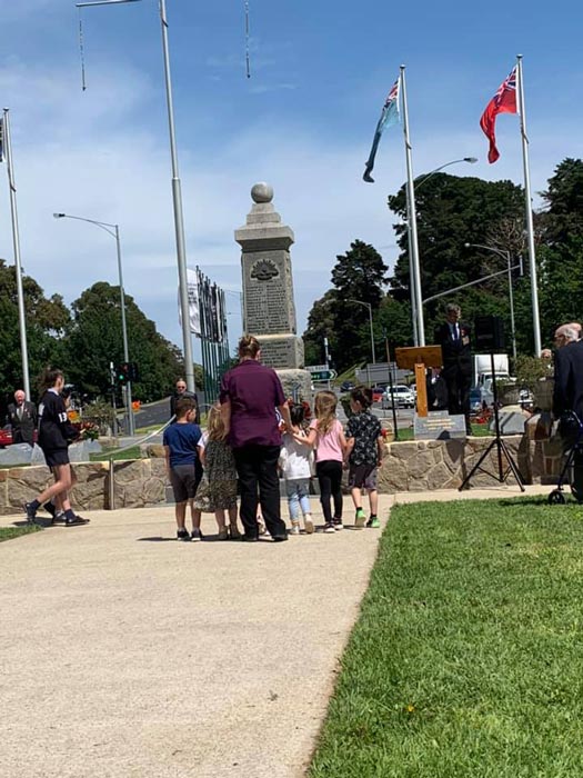 group of kids touring statue