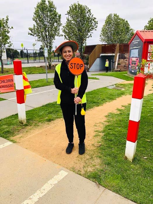 woman holding a stop sign