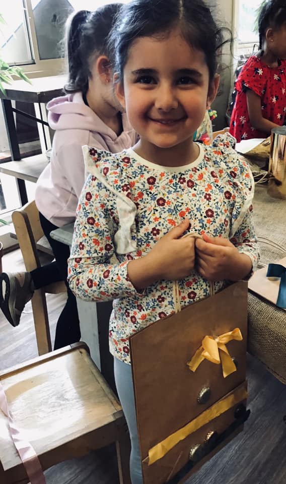 young girl holding a bag