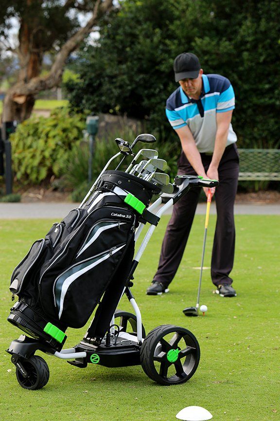 golf bag with man playing golf in the background