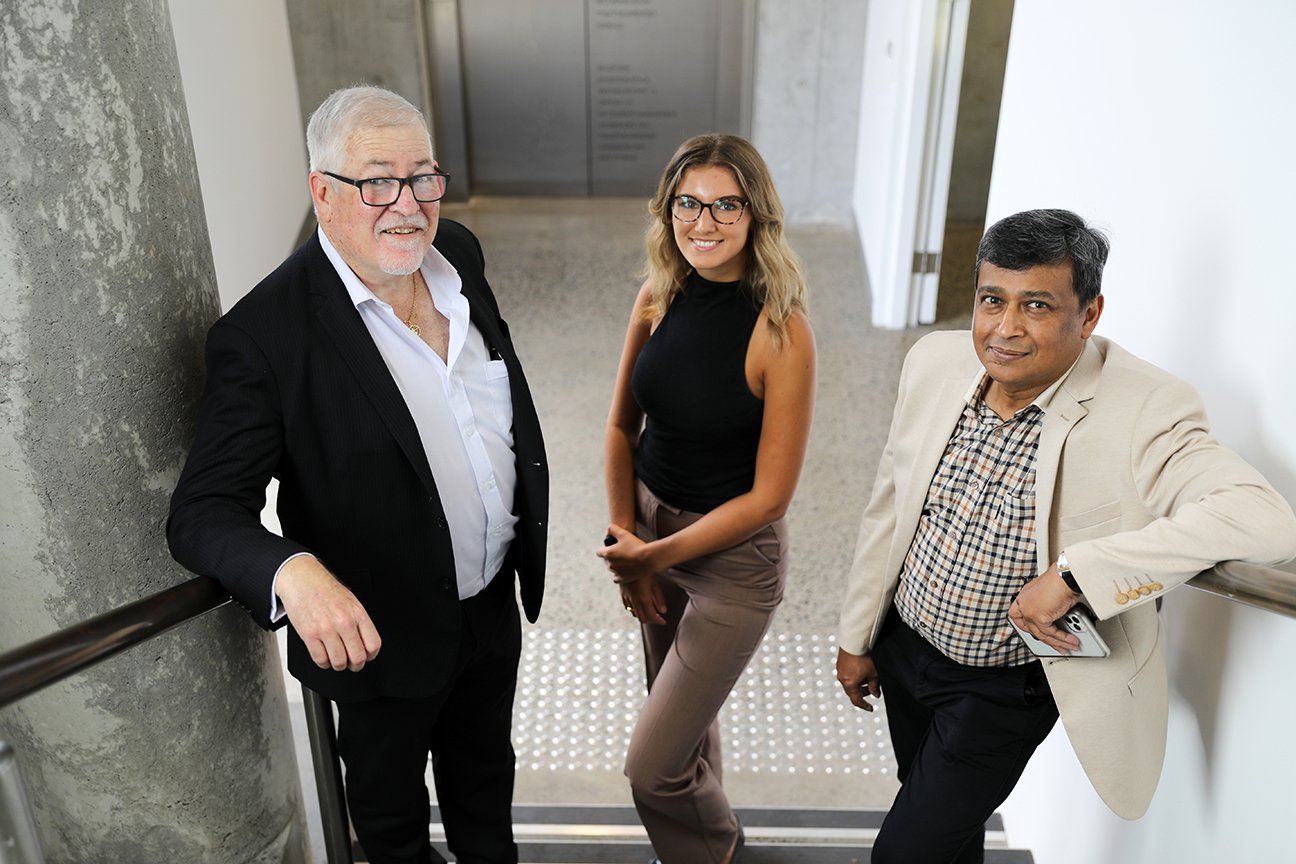 three people posing on the stairwell