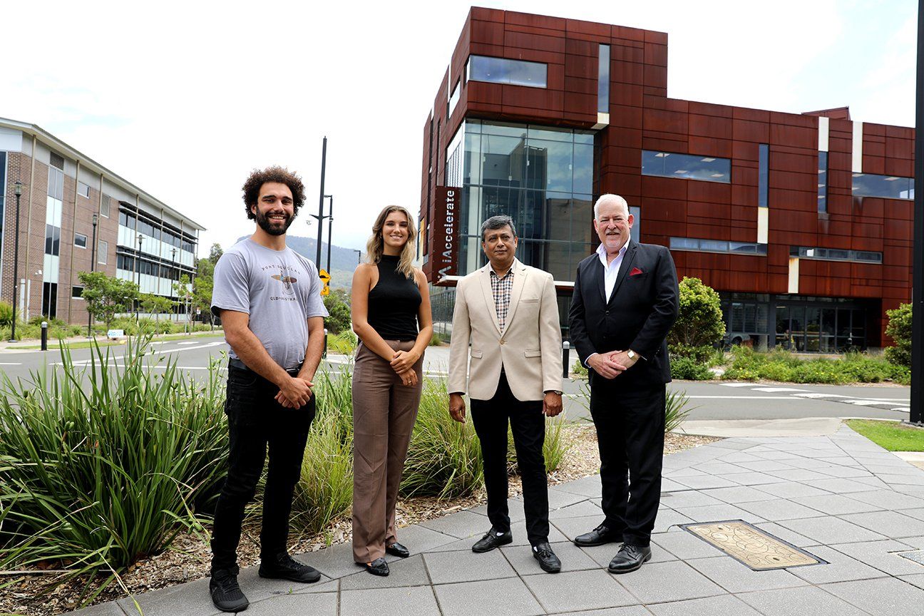group of people posing in front of a building