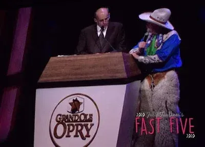A man in a suit and tie is standing at a podium giving a speech.