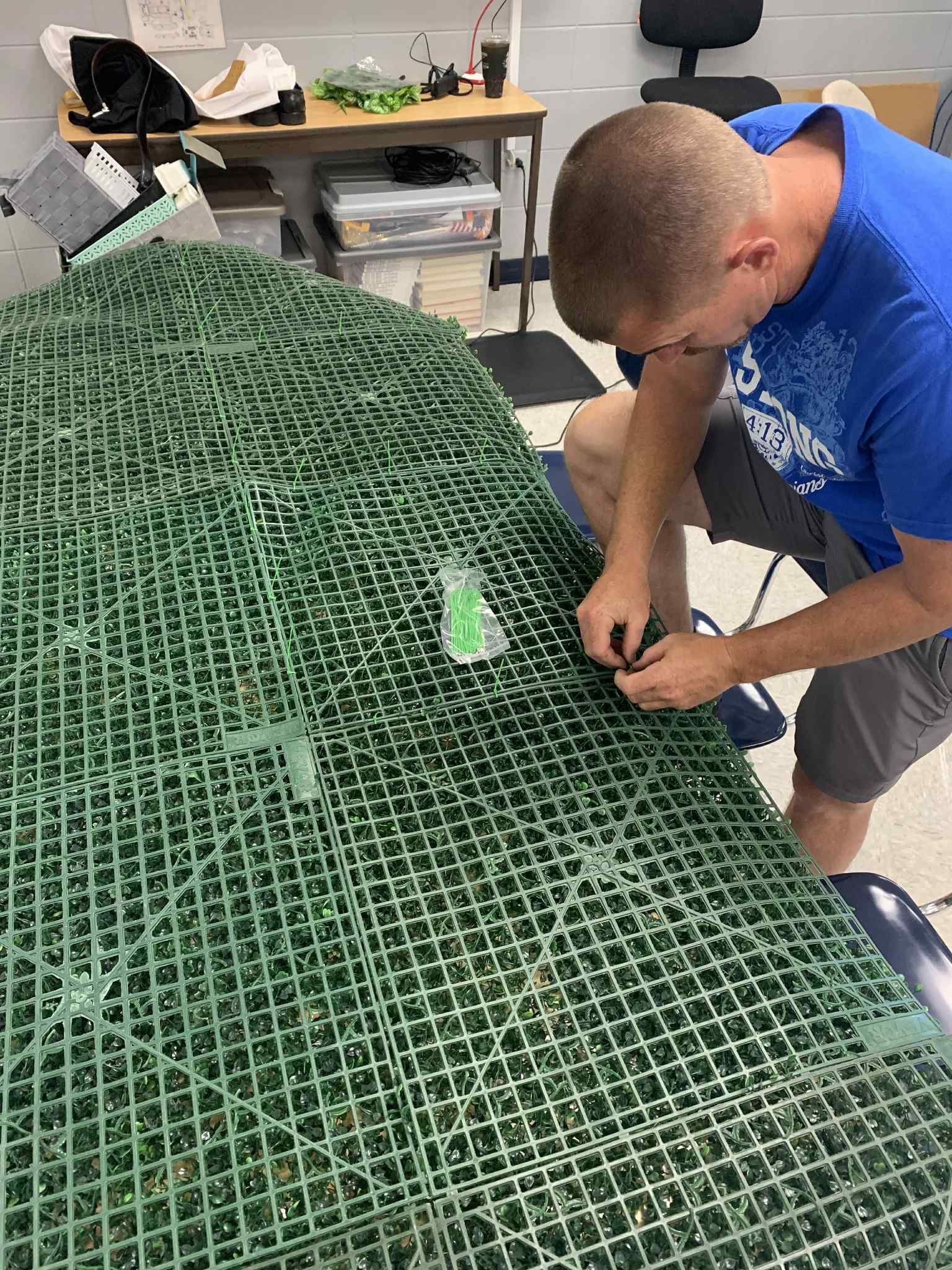 plant theme high school classroom, faux boxwood wall with neon light, jfaulkner