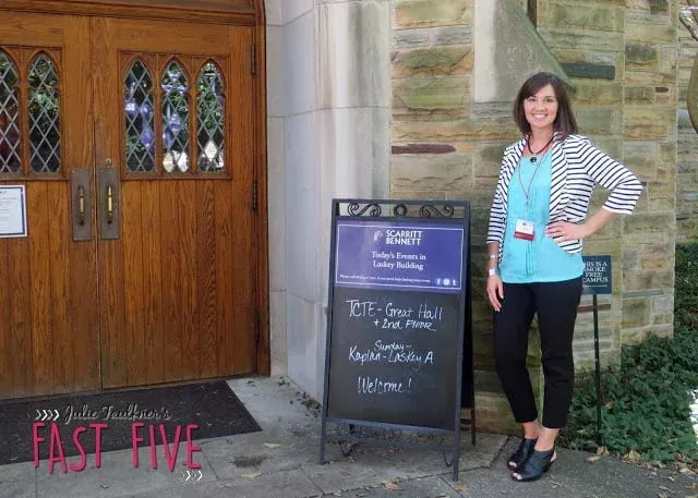 A woman standing in front of a sign that says fast five