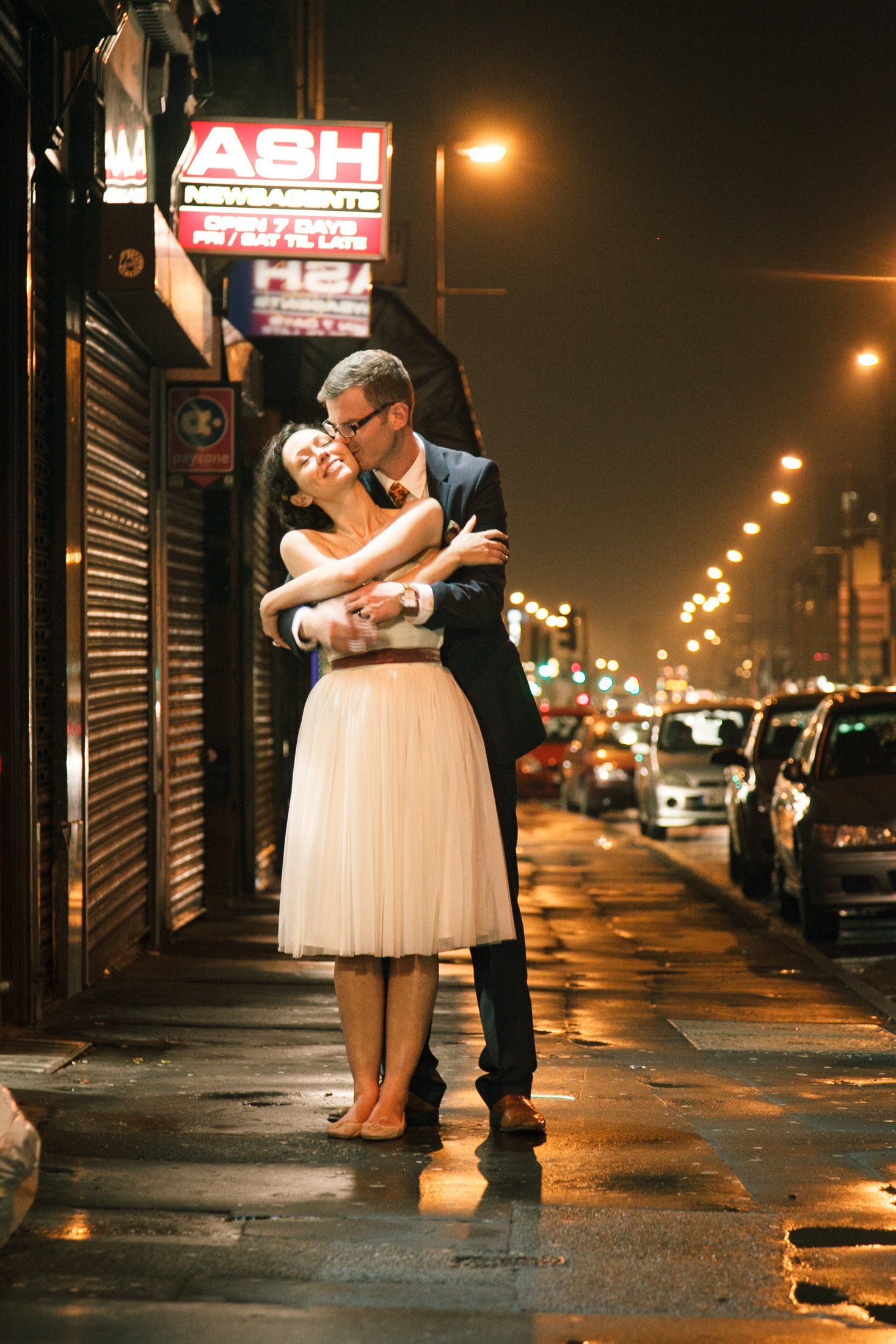 Bride and groom kissing in mancherster near band on the wall