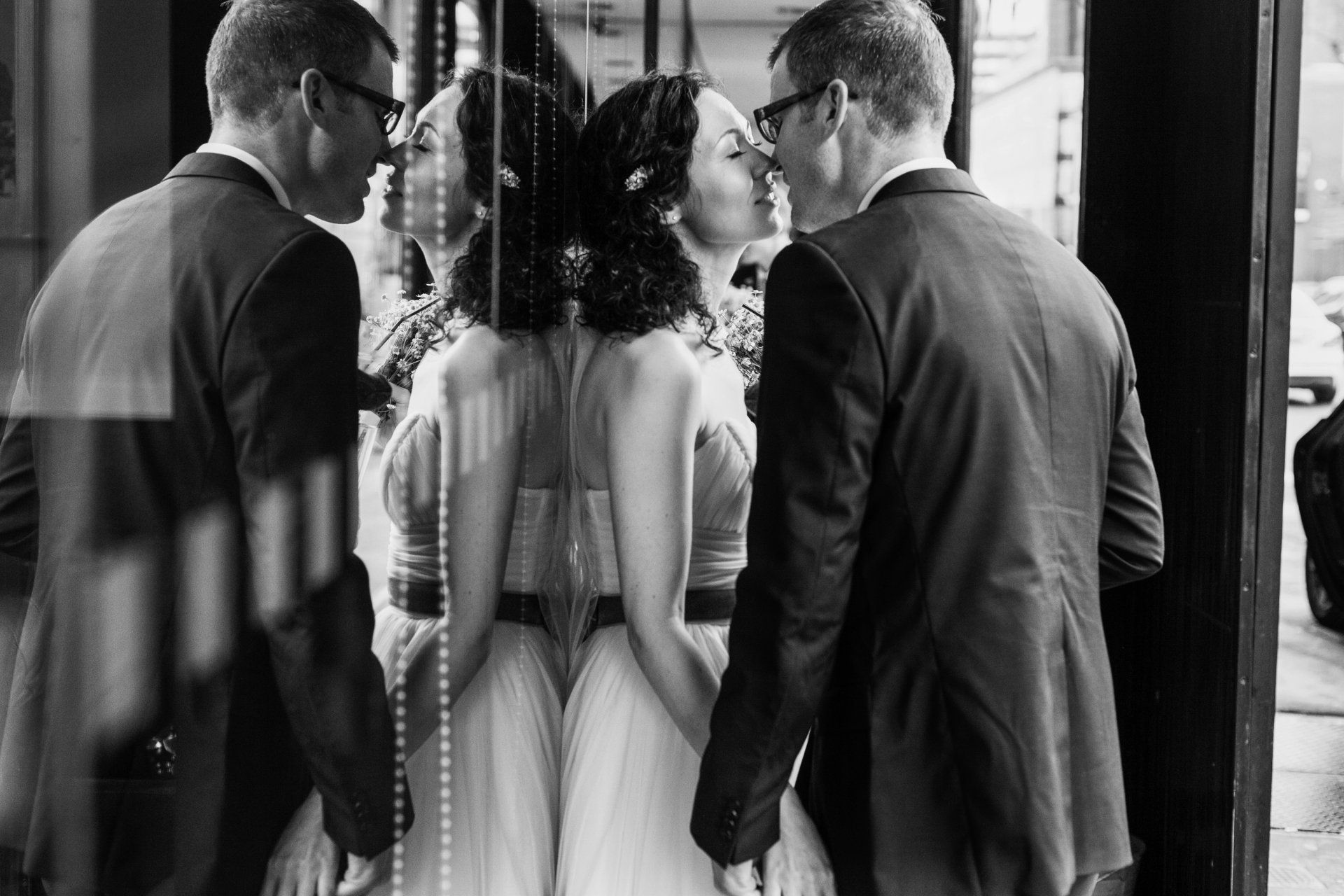 Romantic moment as bride and groom kiss outside band on the wall Manchester