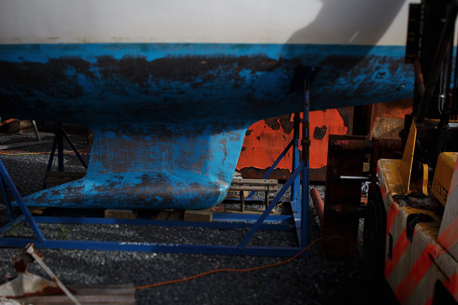 sail boat in Gweek boatyard Cornwall deep colours