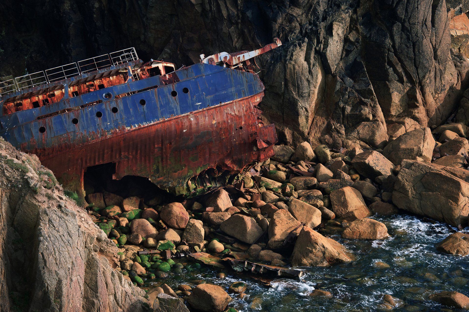 rusty ship wreck on the rocks at land's end cornwall
