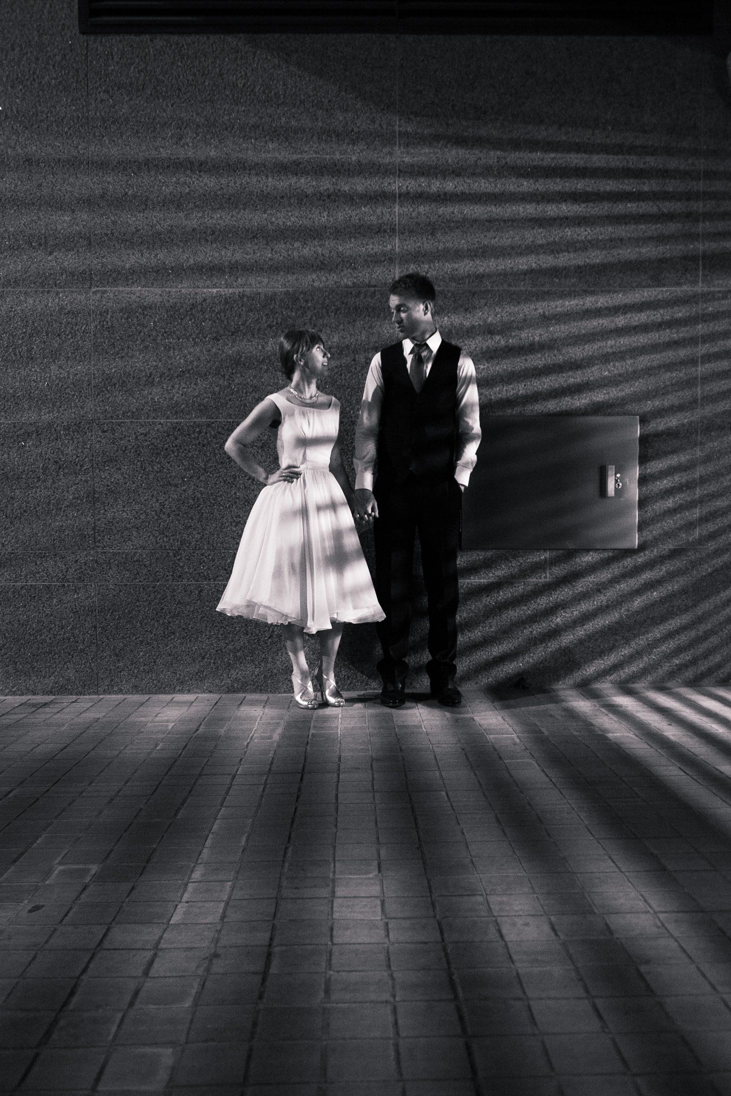 Bride and groom holding hands near kings street