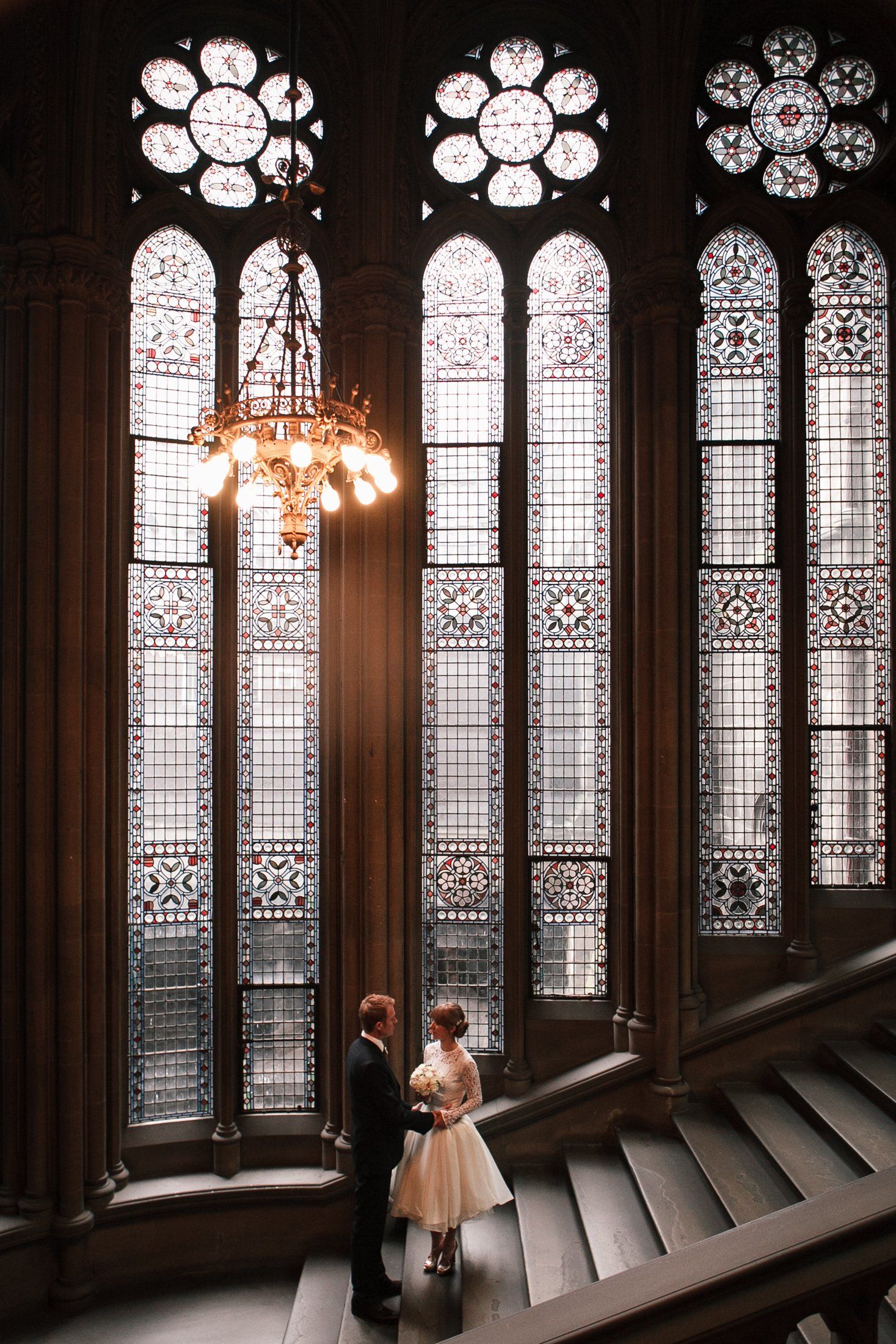 Wedding at Manchester Town Hall bride and groom under chandelier lights