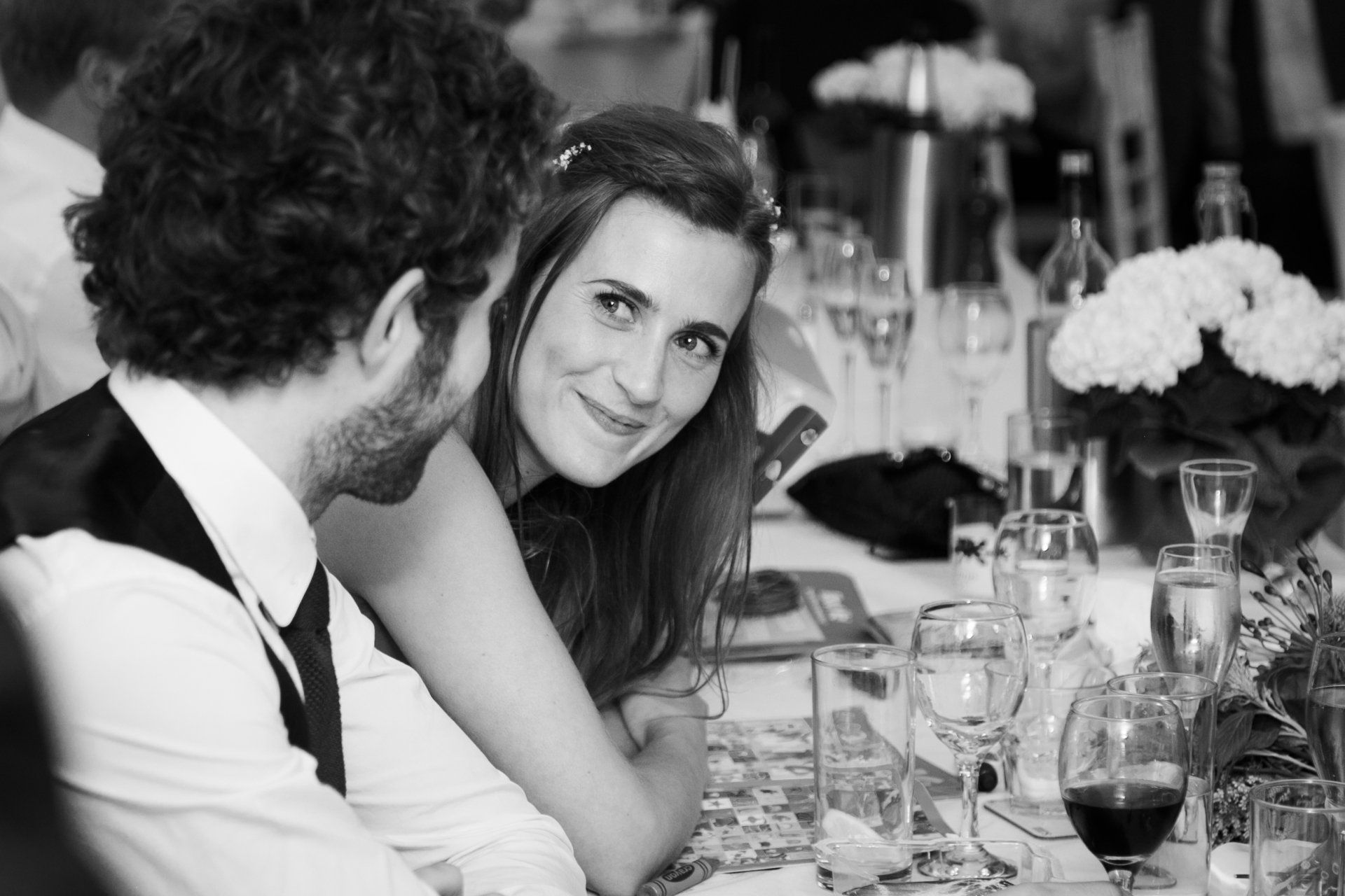 bride lovingly looks at groom during speeches at the wizard pub
