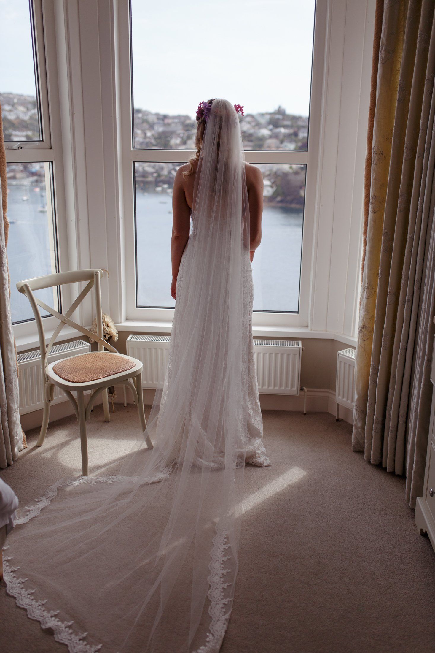 Fowey wedding photos bride looks out over the water