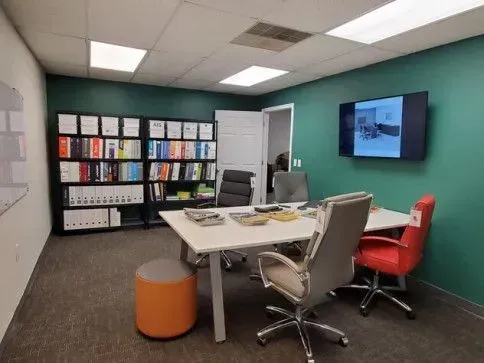 Meeting room with ergonomic chairs and a colorful display wall