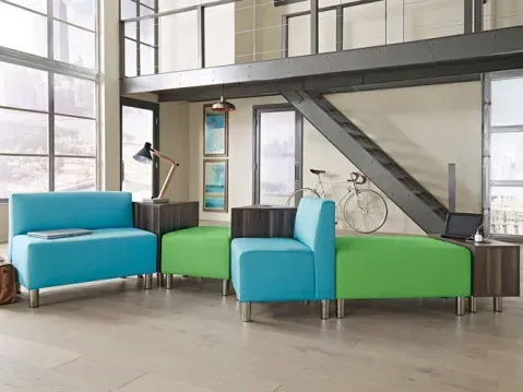 Vibrant office seating area with blue and green furniture elements