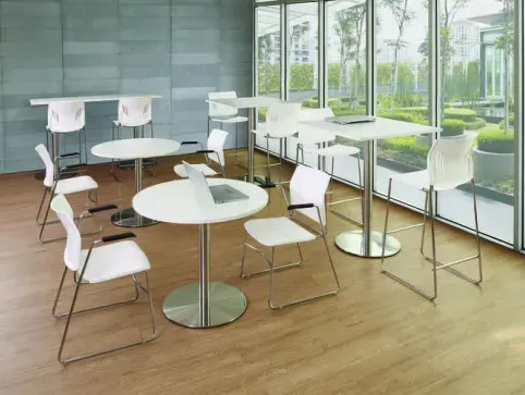 Casual meeting space with tall chairs and round white tables