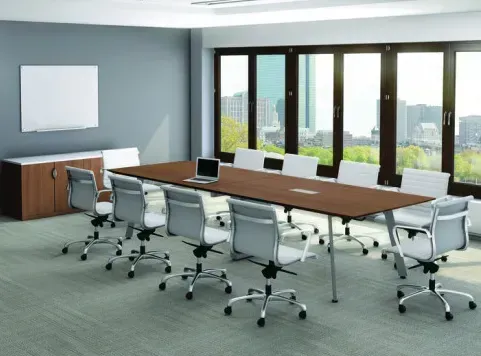 Spacious conference room with a long table and white chairs
