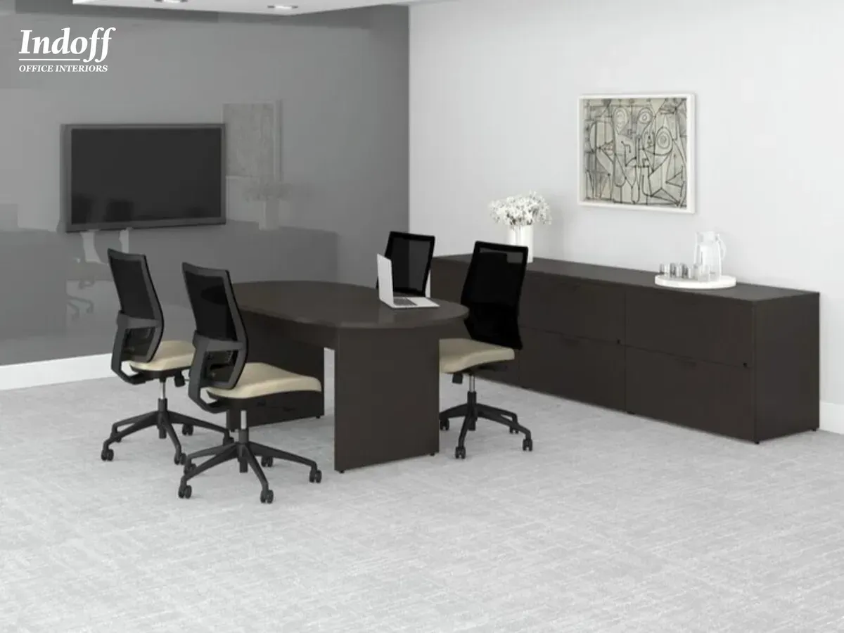A conference room with a table , chairs , and a tv.