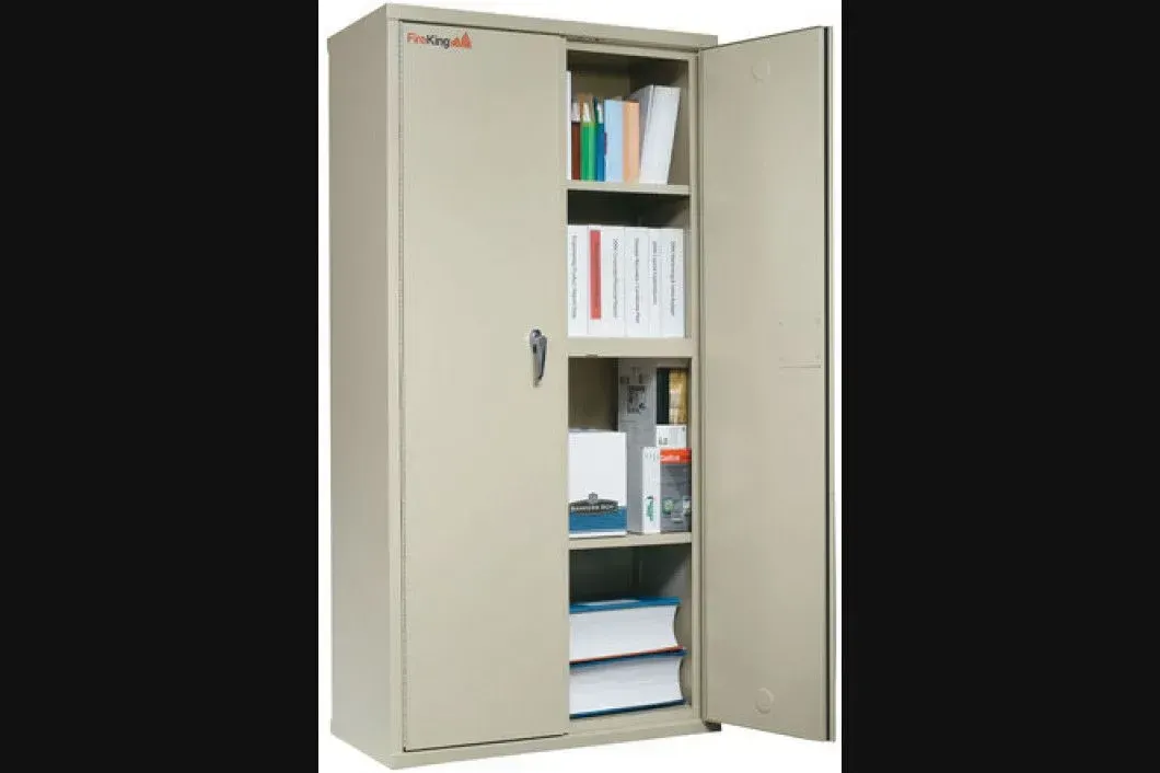 A metal cabinet with the doors open filled with books and folders