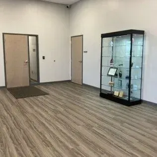 There is a glass display case in the middle of the room.