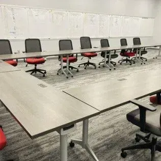 A conference room with a long table and chairs.