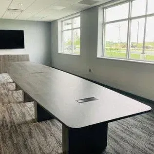 There is a long table in the middle of the room.