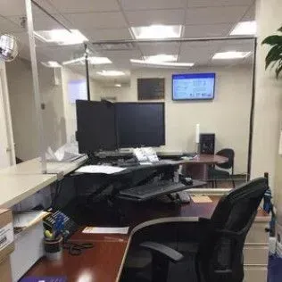 An office with a desk , chair , monitors and a tv.