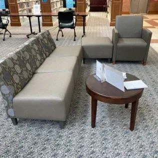 A living room with a couch , chairs , and a table.