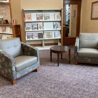 There are two chairs and a table in the room.