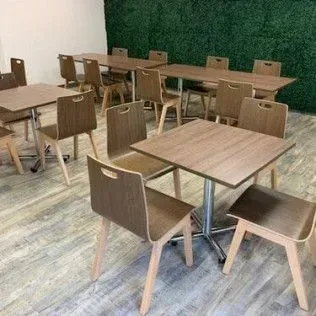 A room filled with wooden tables and chairs.