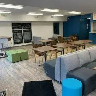 There are many tables and chairs in this room.