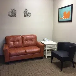 There is a couch and a chair in the room.
