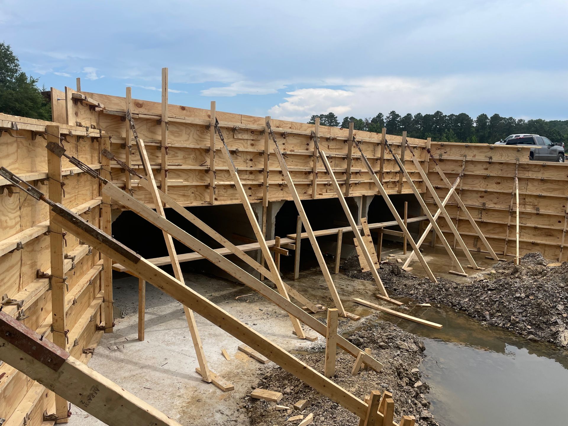 A wooden structure is being built next to a body of water.