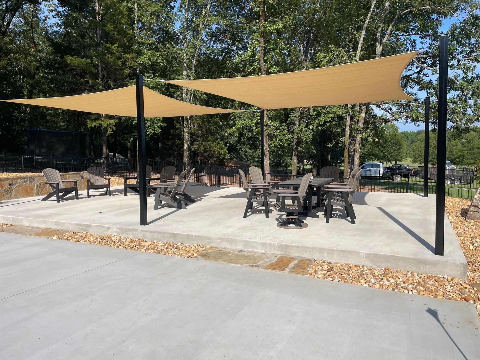 A patio area with tables and chairs under umbrellas.
