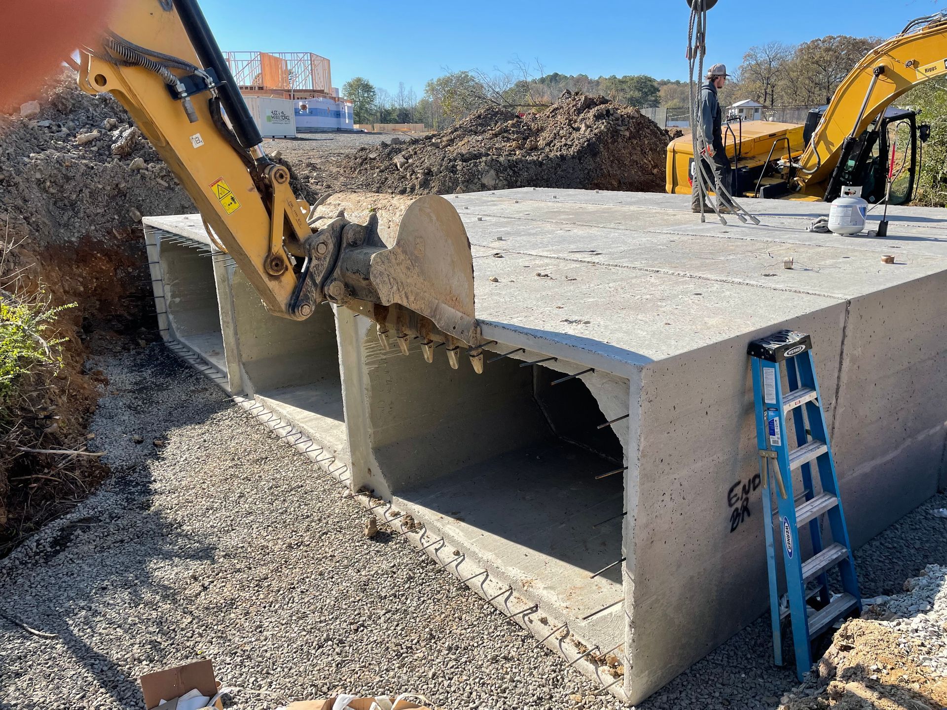 A construction site with a ladder and a bulldozer.