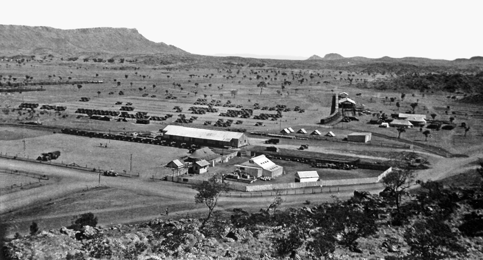 Black and white panoramic view of a small town in a dry, rocky landscape.