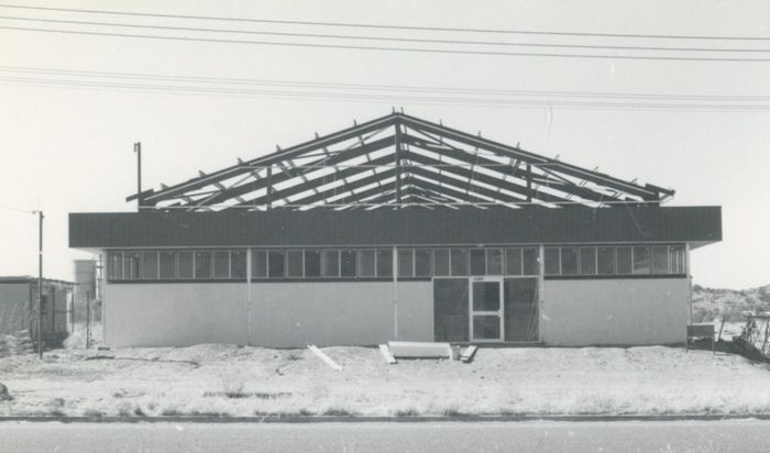 Black and white photo of a low, rectangular building.