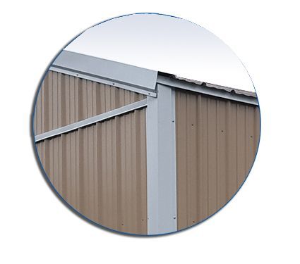 A close up of a brown metal building with a white trim