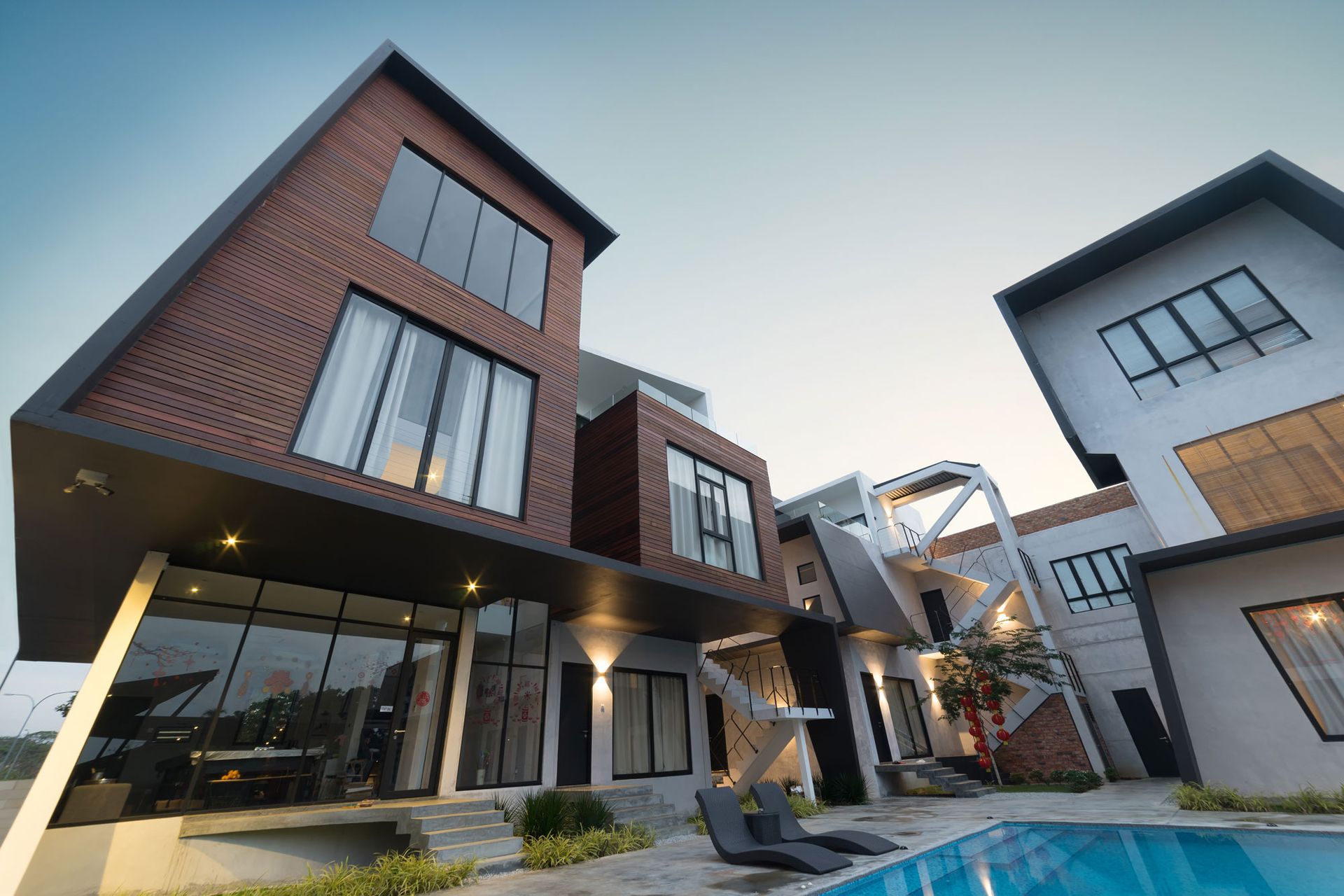 A modern house with a swimming pool in front of it.