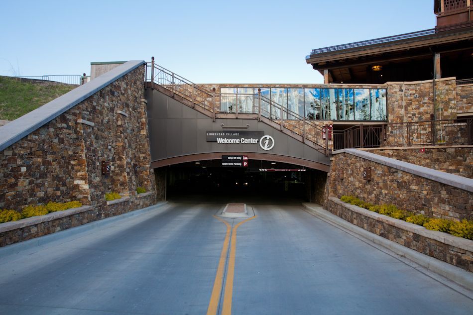An entrance to the Sun Valley Conference Center, featuring stone walls and a road leading into a parking garage.