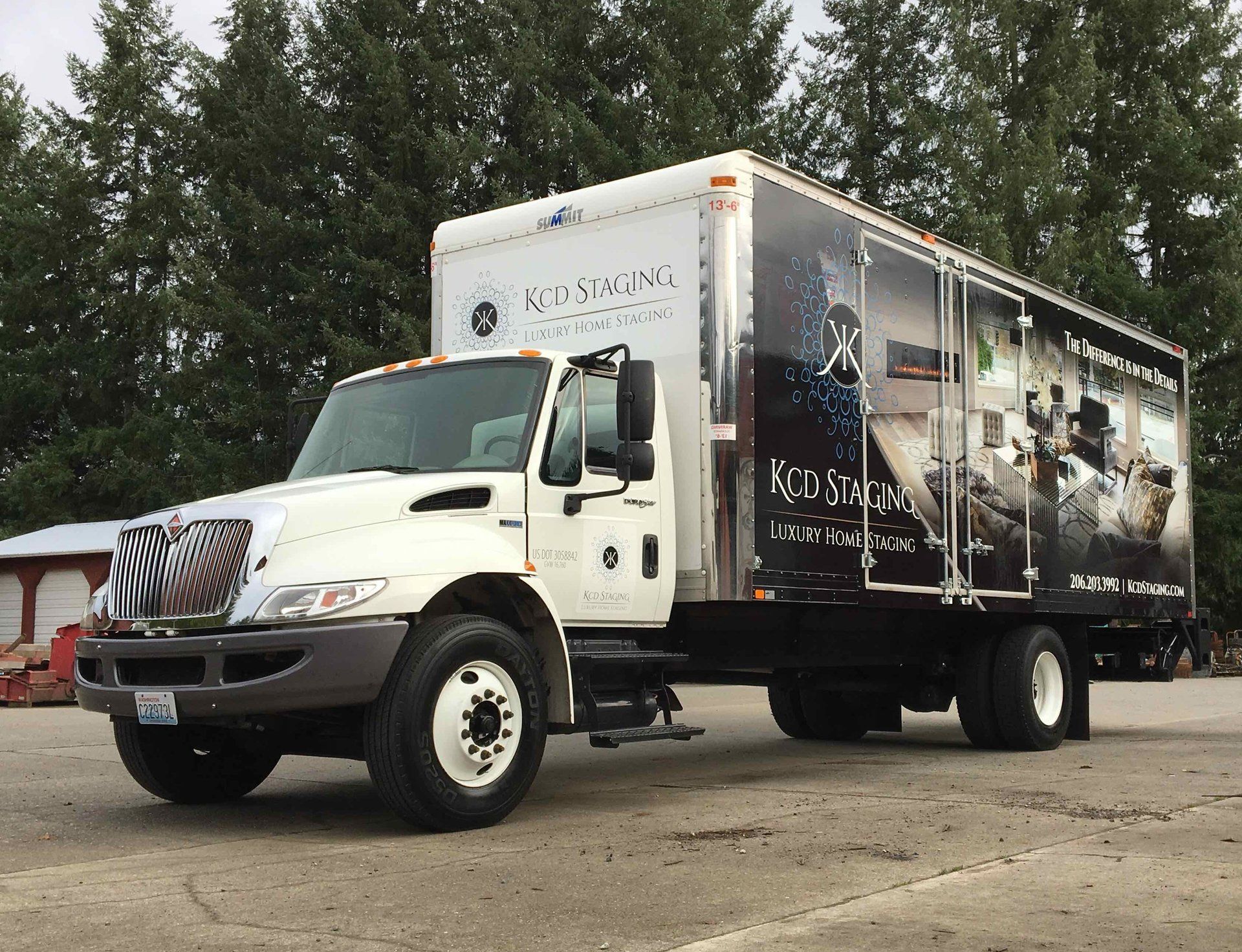 White box truck with company branding parked outside.