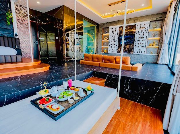 Luxurious modern hotel suite with a floating bed and tray of food.