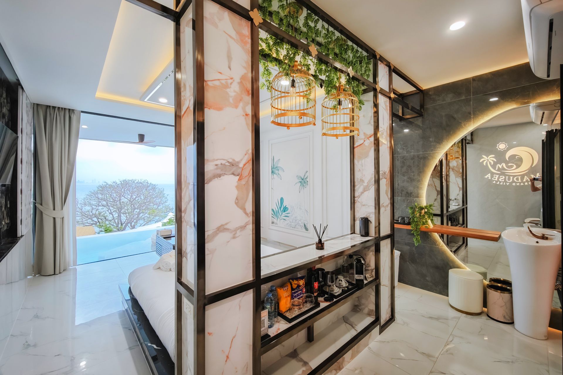 Bedroom with marble accents, open to a balcony, featuring a bed, shelving, and a vanity area.