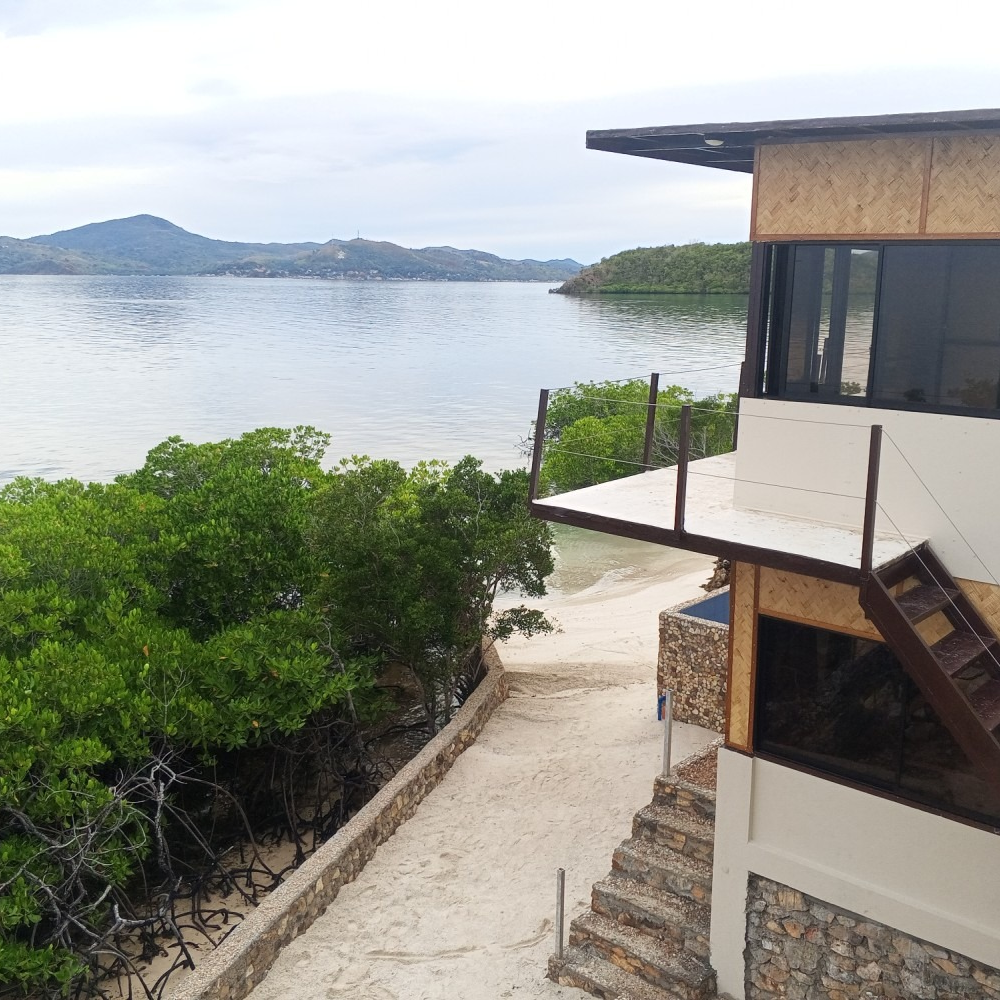 A house with a balcony overlooking a body of water