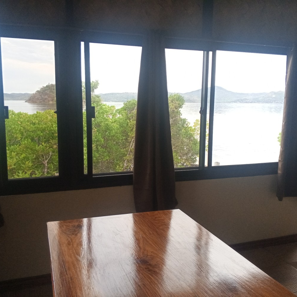 A table in front of a window with a view of a body of water